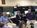 FEMA Administrator Craig Fugate, KK4INZ (right), visits WX4NHC operator Hank Collins, W8KIW, and his wife Pat on October 1. [Julio Ripoll, WD4R, photo] 